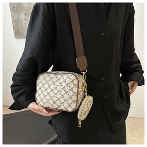 Detail of vintage geometric pattern bag with wide strap and matching mini coin purse