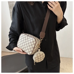 Detail of vintage patterned crossbody square bag with round pouch and wide shoulder strap