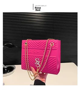 Detail of rose red PU leather shoulder bag with V-quilted pattern and silver buckle