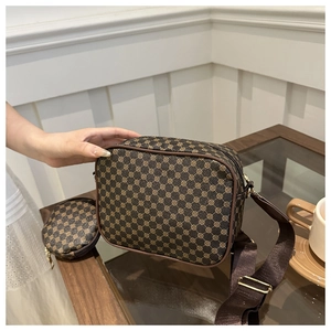 Detail of vintage patterned crossbody bag set with detachable round coin purse and strap