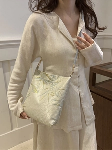 Elegant Chinese style floral jacquard shoulder bag with gold hardware worn by model