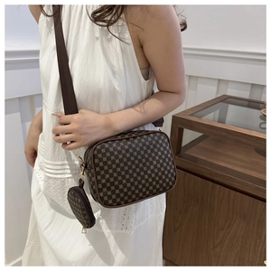 Brown vintage pattern camera bag with wide shoulder strap and round coin pouch detail