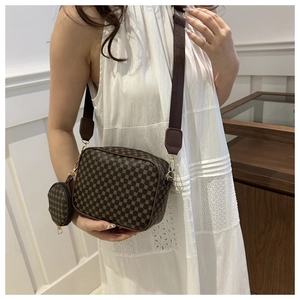 Brown vintage printed crossbody bag with wide strap and mini round coin purse shown on model