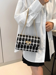 Classic black and white plaid tweed shoulder bag with gold chain and metal clasp