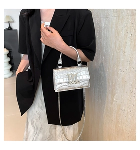 Detail of silver crocodile pattern crossbody bag with gothic metal letter decor