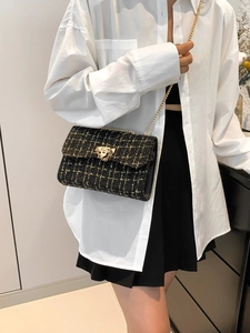 Elegant black and gold tweed plaid shoulder bag with metallic chain and buckle detail