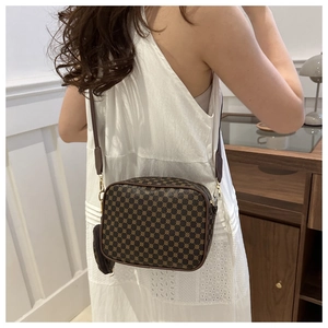 Brown vintage square crossbody bag with floral pattern and small coin purse on shoulder strap