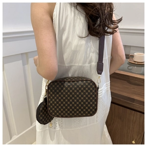 Detail of crossbody bag with geometric pattern, wide strap and mini round coin purse