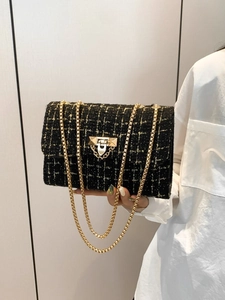 Chic black tweed shoulder bag with gold chain strap and metallic thread accents