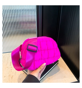 Detalle del bolso acolchado rosa brillante con correa ancha y acabado de nailon fino
