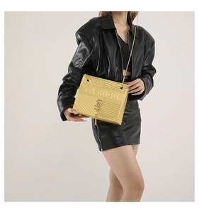 Close-up of golden chain strap and V-quilted texture on casual crossbody handbag
