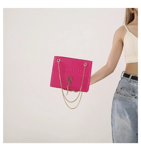 Detail of rose pink quilted leather bag with gold chain strap and fashion logo