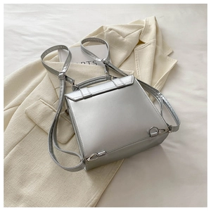 Rear view of silver metallic PU backpack showing adjustable straps and metal ring buckles