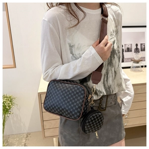 Detailed view of the 2-in-1 crossbody bag featuring geometric patterns and a wide strap
