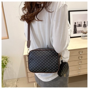 Detailed view of retro printed crossbody camera bag with wide strap and round coin purse