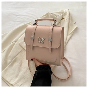 Detail of light pink square backpack with silver butterfly clasp and leather texture