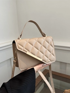 Chic beige quilted crossbody bag with gold hardware and top handle for women