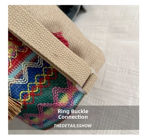 Close-up of woven tote bag with colorful embroidery and transparent buckle detail