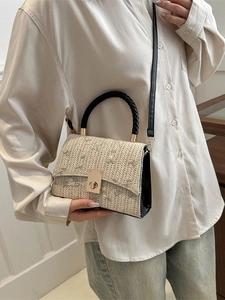Floral embroidered straw crossbody bag with gold twist lock and black leather shoulder strap