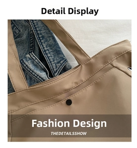 Macro shot of khaki tote bag showing reinforced double stitching and metal snap button closure