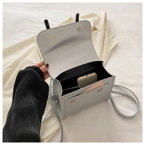 Top view of compact crossbody bag showing main compartment and front pocket capacity