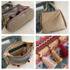 Detailed view of ethnic tote bag showing colorful geometric embroidery and boho tassels