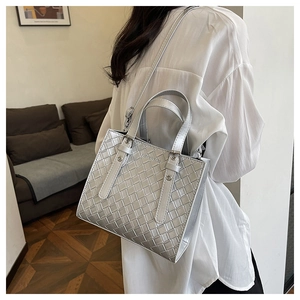 Detail of silver woven texture tote bag with Fashion Bags logo and adjustable strap
