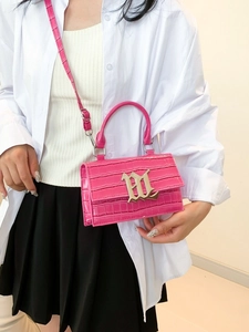 Pink croc-embossed square handbag with silver chain strap and gothic buckle detail
