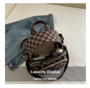 Top view showing the internal capacity of a small brown checkered backpack with daily items