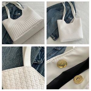 Detail of white woven leather tote bag showing golden magnetic buckle and inner lining