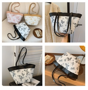 Detailansicht großer Tote-Bags mit Schmetterlingsdruck in Schwarz, Rosa und Khaki