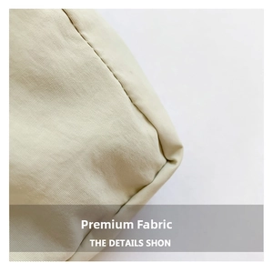 Detailed macro shot of premium beige nylon fabric with fine diagonal weave and stitching