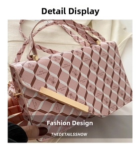 Detailed macro view of pink checkered bear pattern and gold metal clasp on small crossbody bag