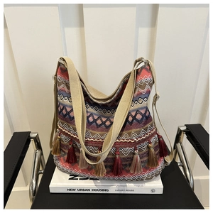 Macro detail of the Bohemian woven hobo bag showing colorful geometric patterns and fringe