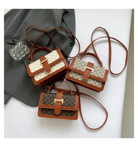 Detailed overhead view of three vintage monogram crossbody bags with leather trim
