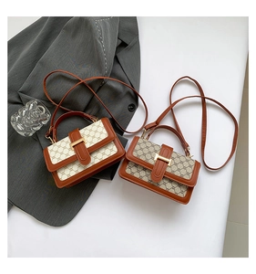 Detail of vintage canvas crossbody bags with classic patterns and gold metal buckles