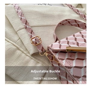 Detail view of pink and brown plaid shoulder bag with bear print and gold hardware