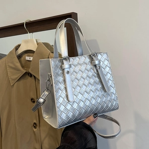 Silver woven texture handbag with top handles and adjustable strap in urban minimalist style