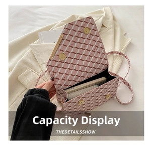 Detailed interior view of plaid crossbody bag showing storage space for phone and wallet