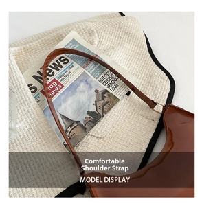 Detail of a brown patent leather shoulder bag with a sleek metallic ring and comfy strap