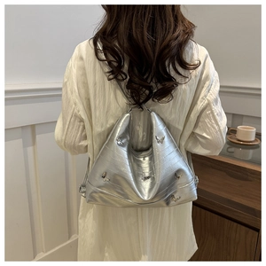 Silver tote bag with 3D butterflies and crocodile texture worn on shoulder