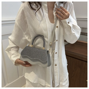 Elegant sequined mini handbag with wave-cut base and silver rhinestones on light grey flap
