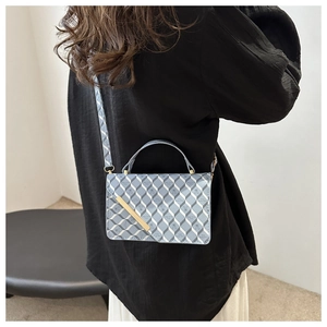 Side view of printed shoulder bag with geometric patterns and golden metal buckle