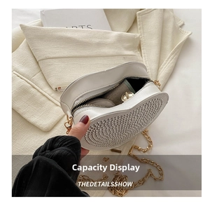 Detailed interior of heart evening bag showing storage for makeup and accessories