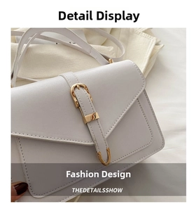 Detailed close-up of cream flap bag showing gold buckle and fine stitching texture