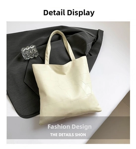 Dettaglio della borsa tote crema oversize con cuciture geometriche e pelle PU di qualità