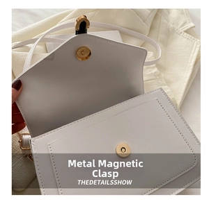 Close-up of premium white square handbag with magnetic snap closure and neat stitching