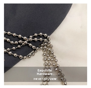 Macro shot of polished silver spherical metal chain straps for a luxury evening bag