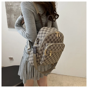 Detail view of the brown lattice pattern and golden zipper on the casual backpack