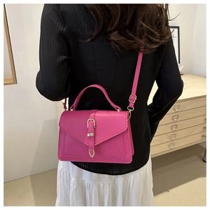 Magenta crossbody bag with metal buckle detail and adjustable strap for women